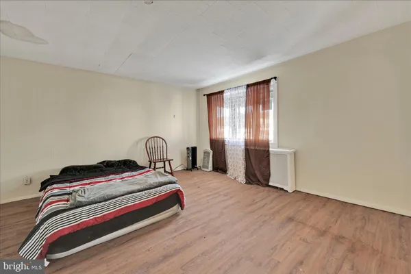 a bedroom with a bed and a night stand