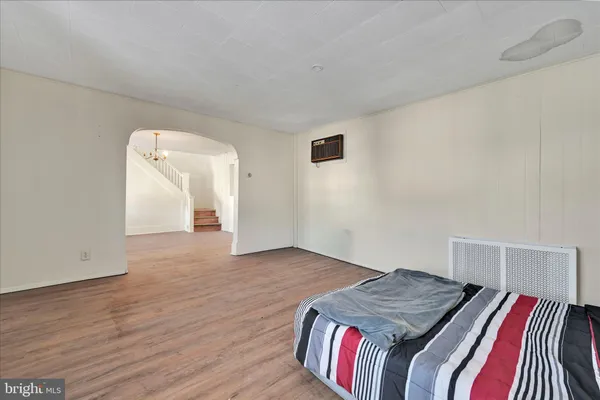 a view of a kitchen with wooden floor and electronic appliances