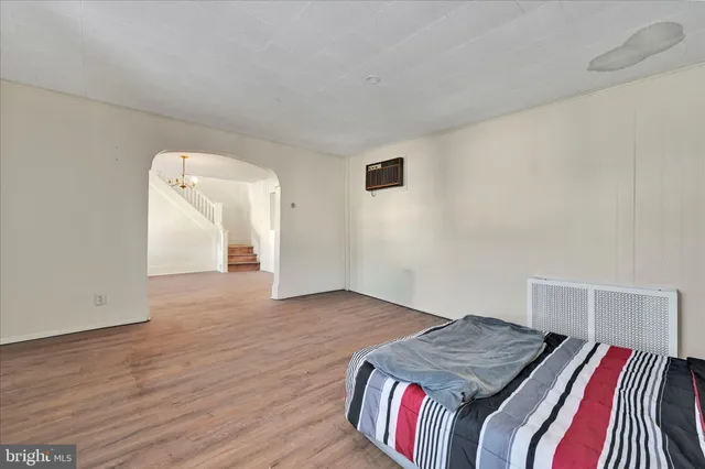 a view of a kitchen with wooden floor and electronic appliances