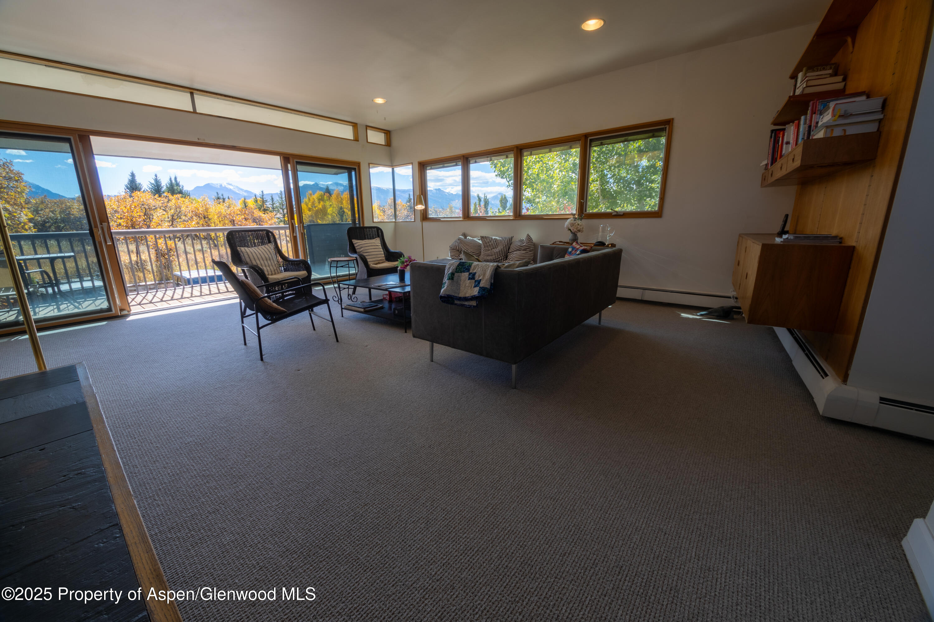 623 Johnson Drive Aspen, CO 81612 - Photo 12 of 35 a living room with furniture and a floor to ceiling window