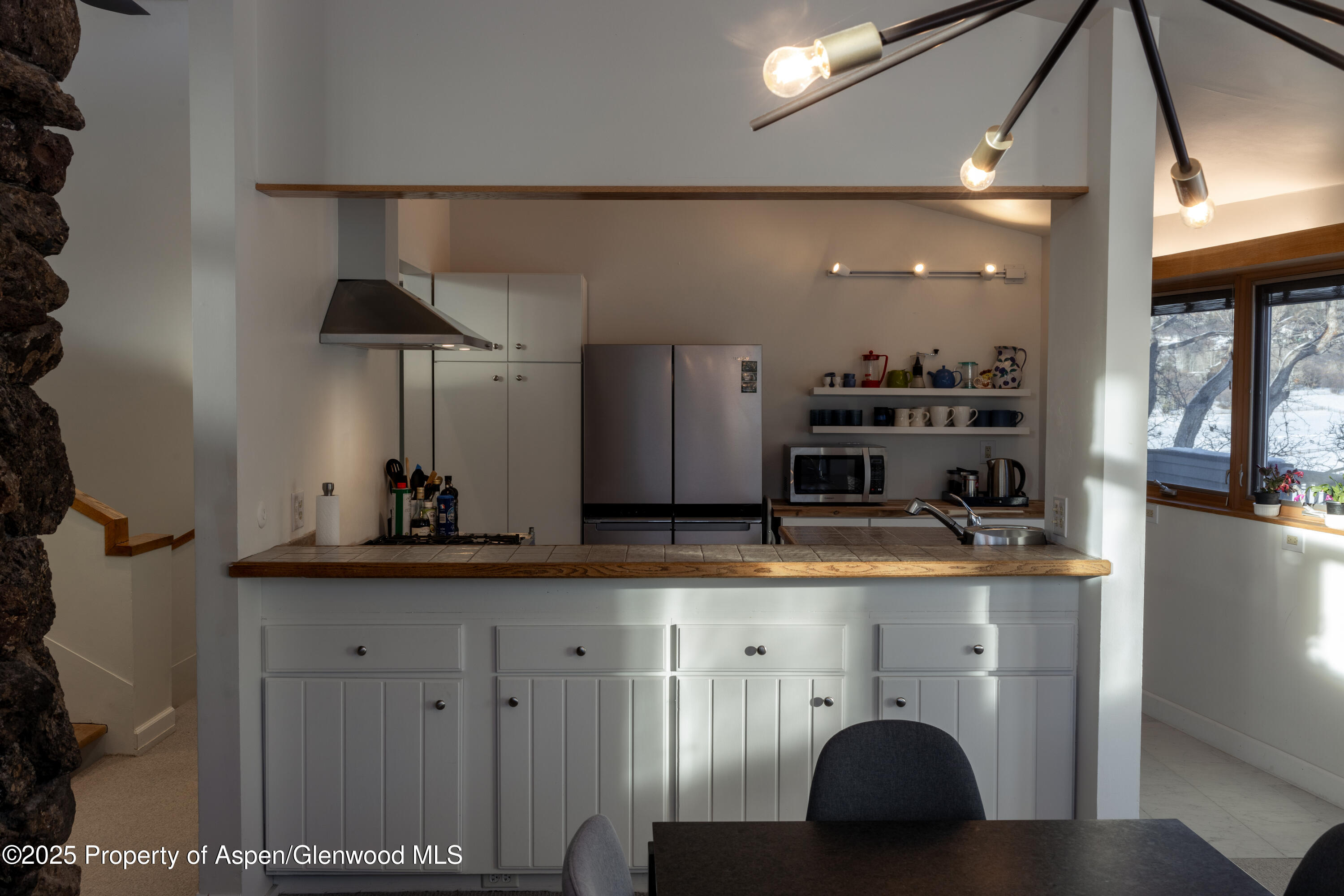 623 Johnson Drive Aspen, CO 81612 - Photo 14 of 35 a kitchen with kitchen island granite countertop a sink a stove and cabinets
