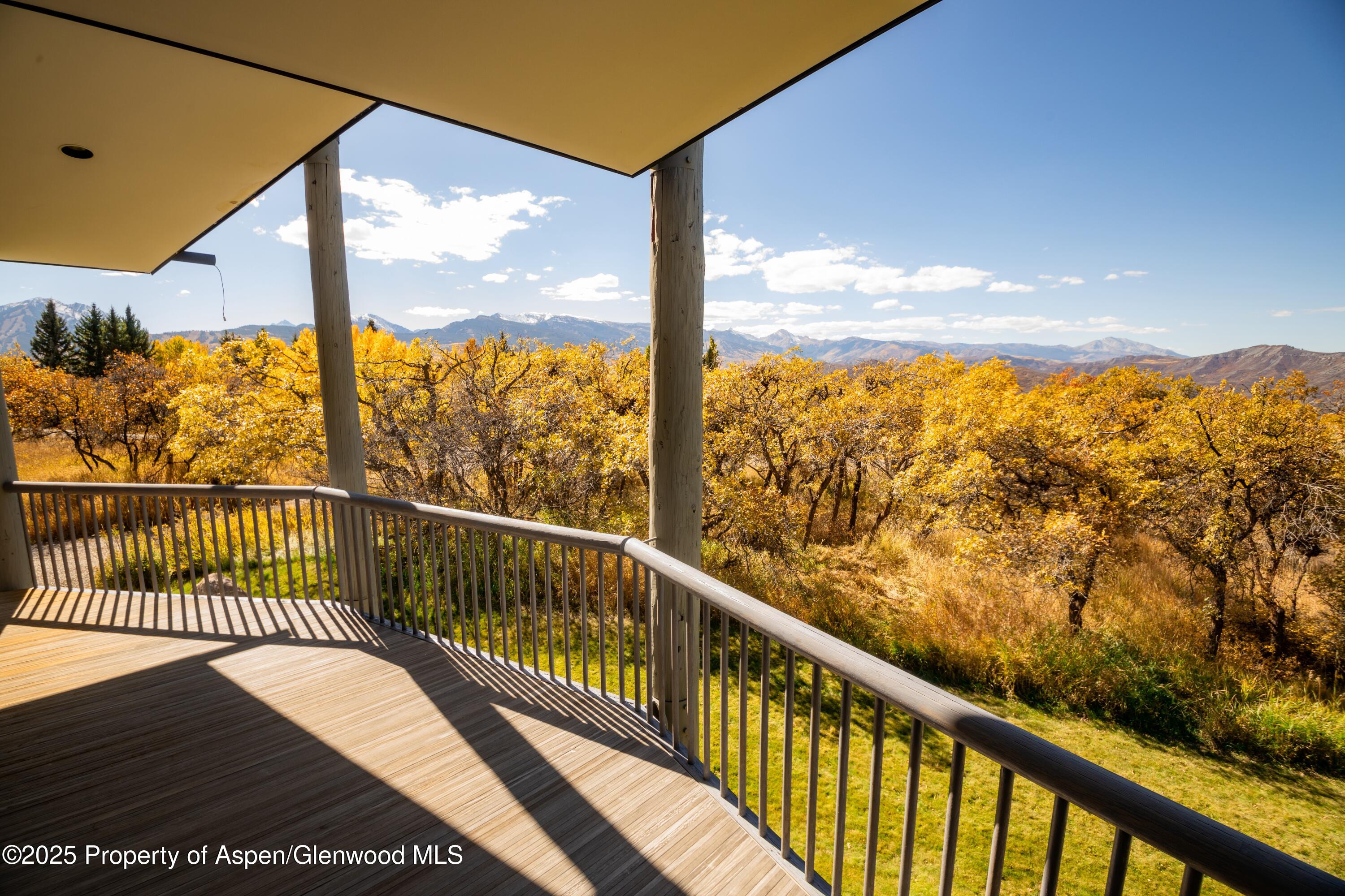 623 Johnson Drive Aspen, CO 81612 - Photo 20 of 35 a view of balcony with floor to ceiling windows with wooden floor