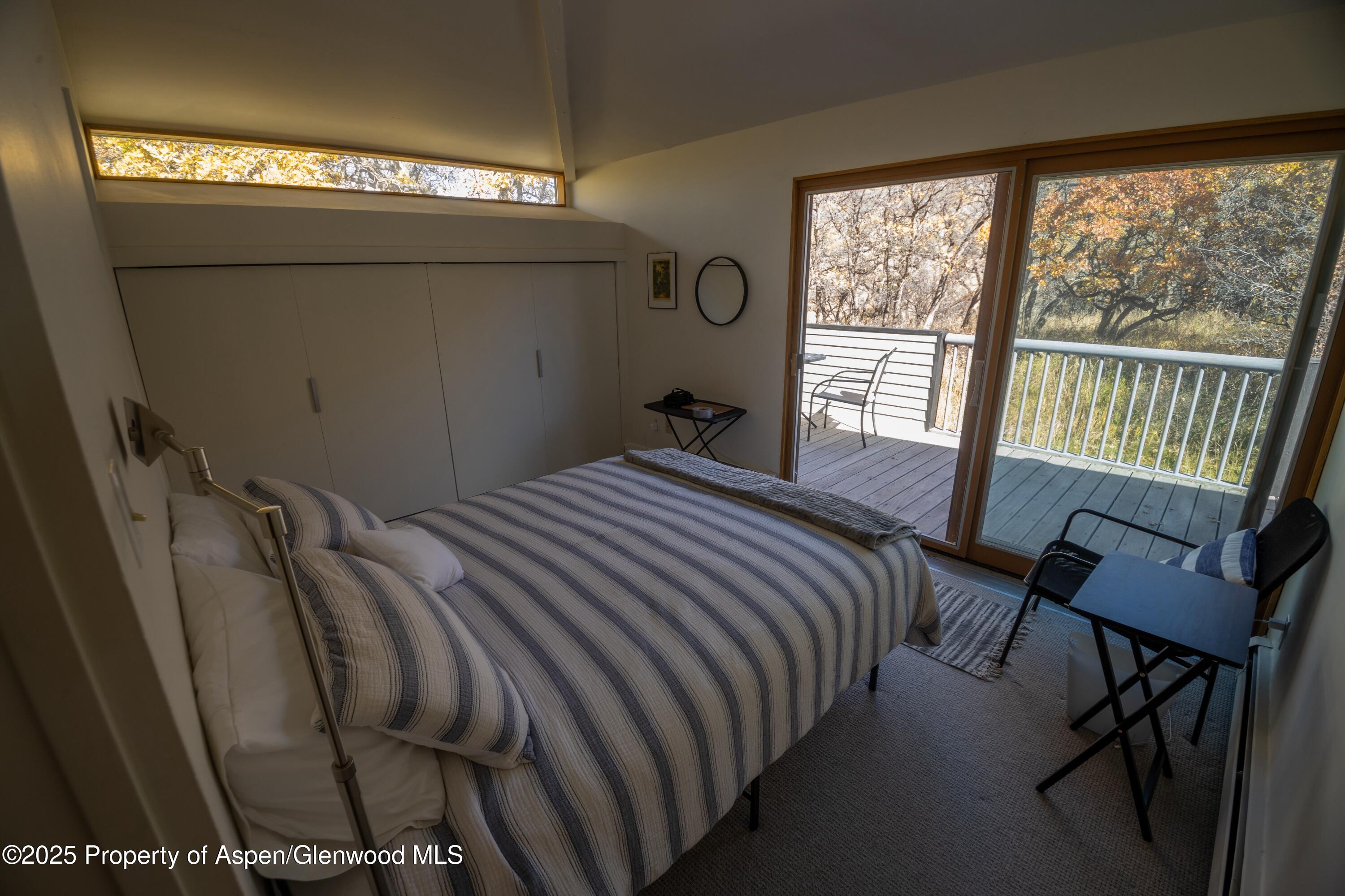 623 Johnson Drive Aspen, CO 81612 - Photo 26 of 35 a bedroom with a bed chair and window