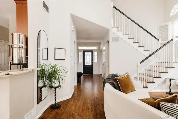 a living room with furniture and wooden floor