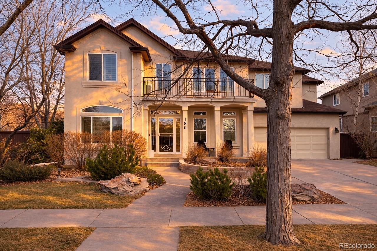 180 South Oneida Street Denver, CO 80230 - Photo 2 of 40 a view of a white house with large windows next to a road