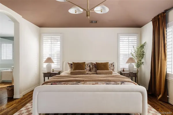 a bedroom with a bed and a large window