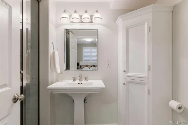 a bathroom with a sink a mirror and vanity