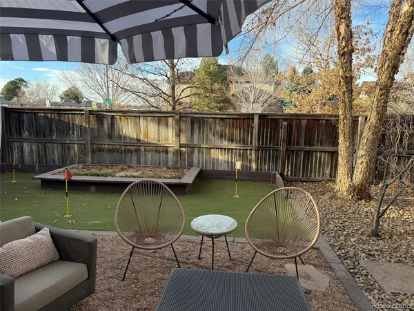 a view of a chairs and table in the roof deck