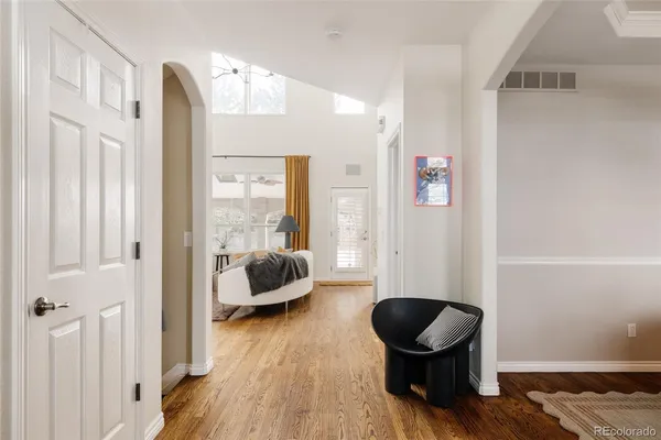 a living room with furniture and a wooden floor