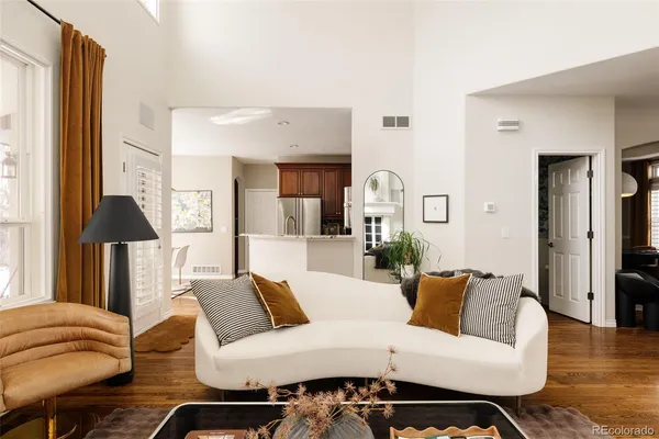 a living room with furniture and a lamp