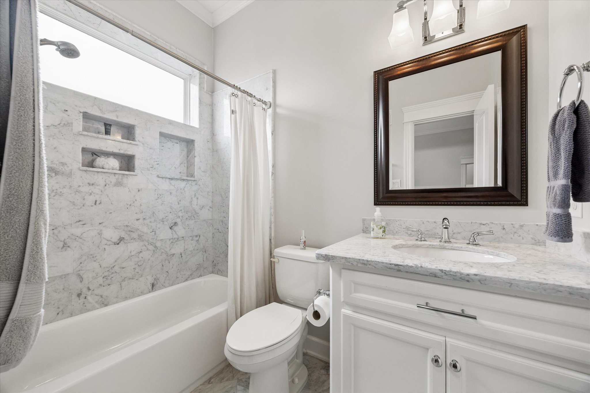 609 Rutland Street, Unit A Houston, TX 77007 - Photo 25 of 30 a bathroom with a bathtub shower sink vanity mirror and toilet