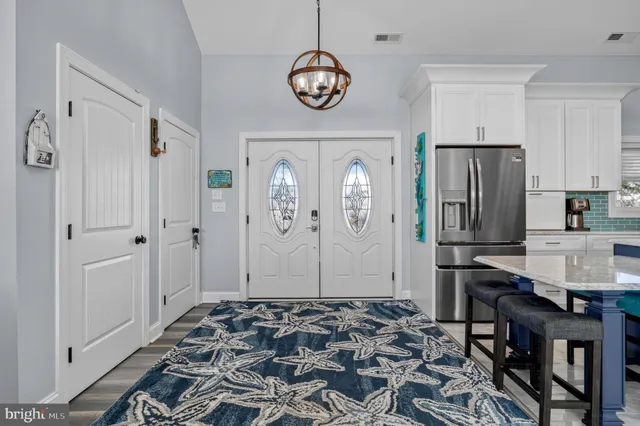 a living room with furniture a large window and a table
