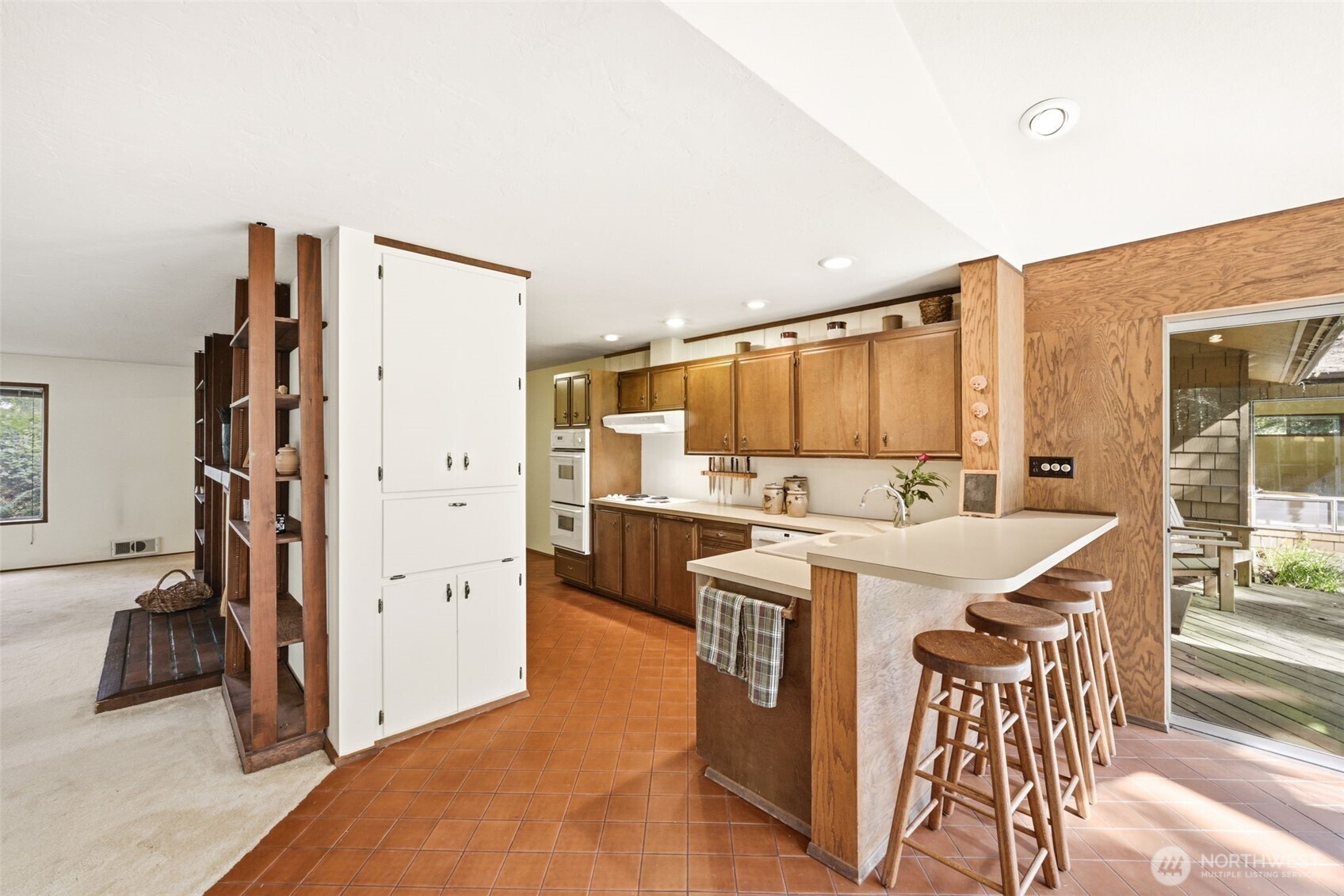 20319 92nd Avenue West Edmonds, WA 98020 - Photo 8 of 26 a open kitchen with stainless steel appliances a stove top oven a refrigerator a dining table and chairs