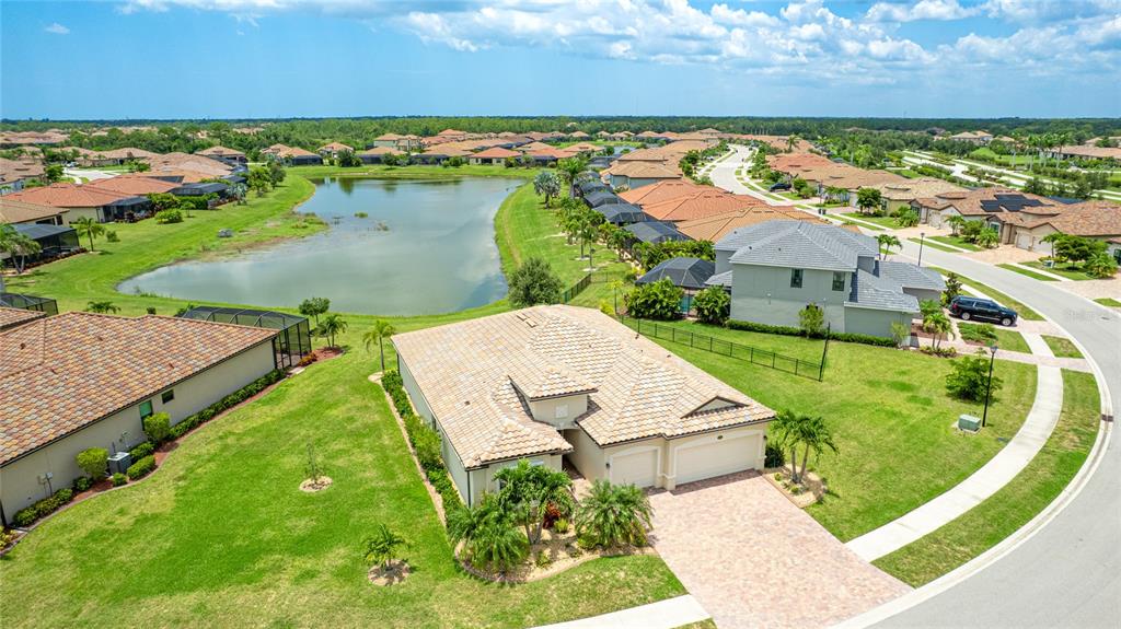 20661 Benissimo Drive Venice, FL 34293 - Photo 1 of 1 an aerial view of a house with a garden and lake view