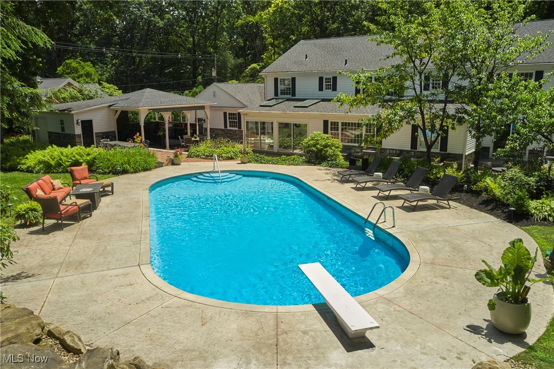 2285 Lancaster Road Akron, OH 44313 - Photo 2 of 48 View of swimming pool with a patio, a diving board, and view of scattered trees