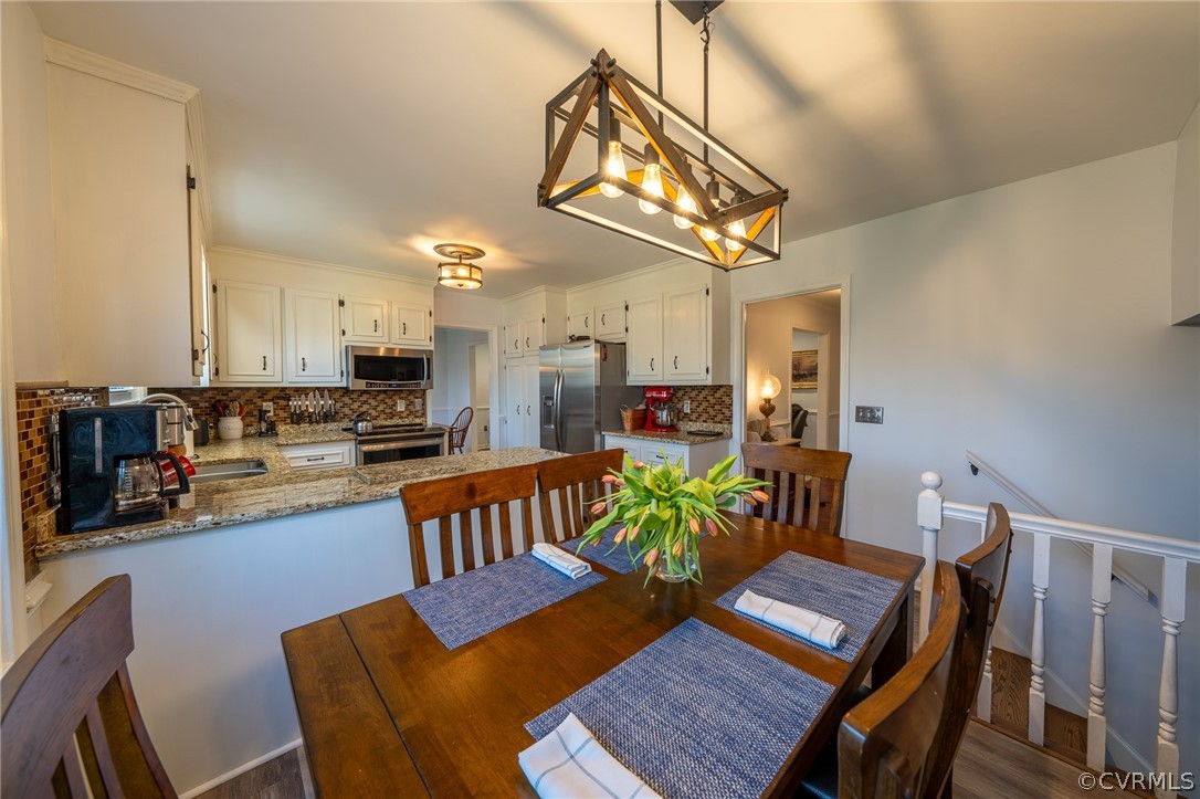 6720 Greenyard Road Chester, VA 23831 - Photo 32 of 46 a view of a dining room with furniture and a kitchen counter