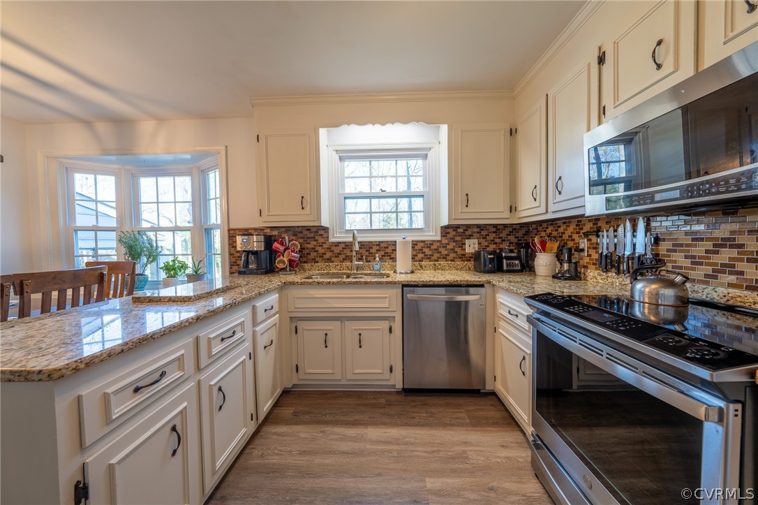 6720 Greenyard Road Chester, VA 23831 - Photo 34 of 46 a kitchen with stainless steel appliances granite countertop a stove sink and cabinets