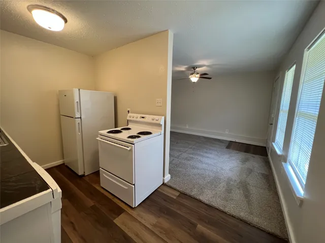 a kitchen with a refrigerator and a stove