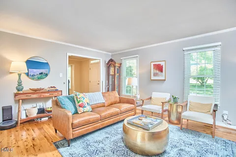 a view of a bedroom with furniture and wooden floor