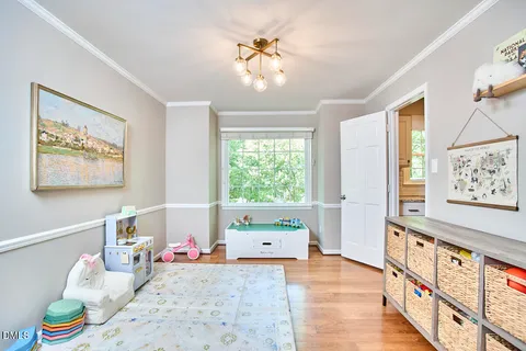 a kitchen with granite countertop a refrigerator a stove a sink a dining table and chairs