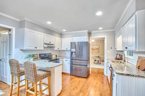 a kitchen with a stove and potted plant
