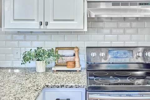 a kitchen with stainless steel appliances granite countertop a sink stove and window