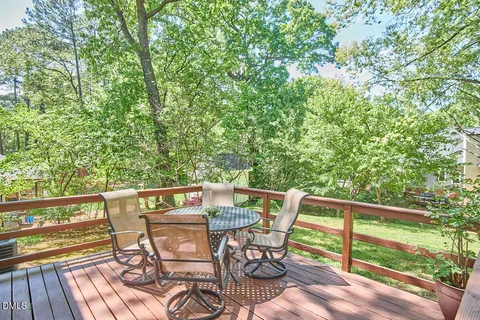 a view of a patio with table and chairs with wooden fence and plants