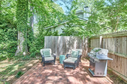 a view of a house with a big yard and large trees