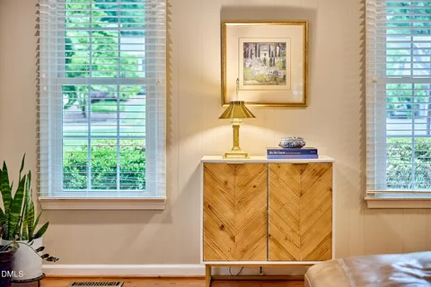 a bathroom with a window and a bed