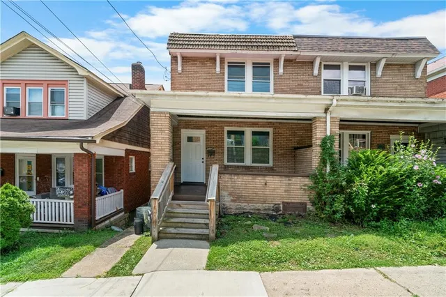 a front view of a house with a yard
