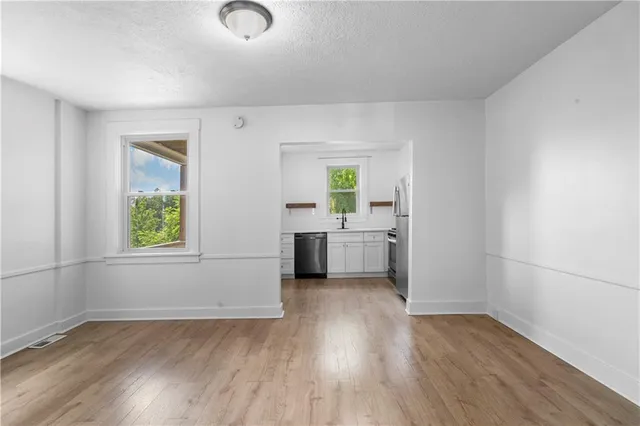 an empty room with a bathroom and a sink