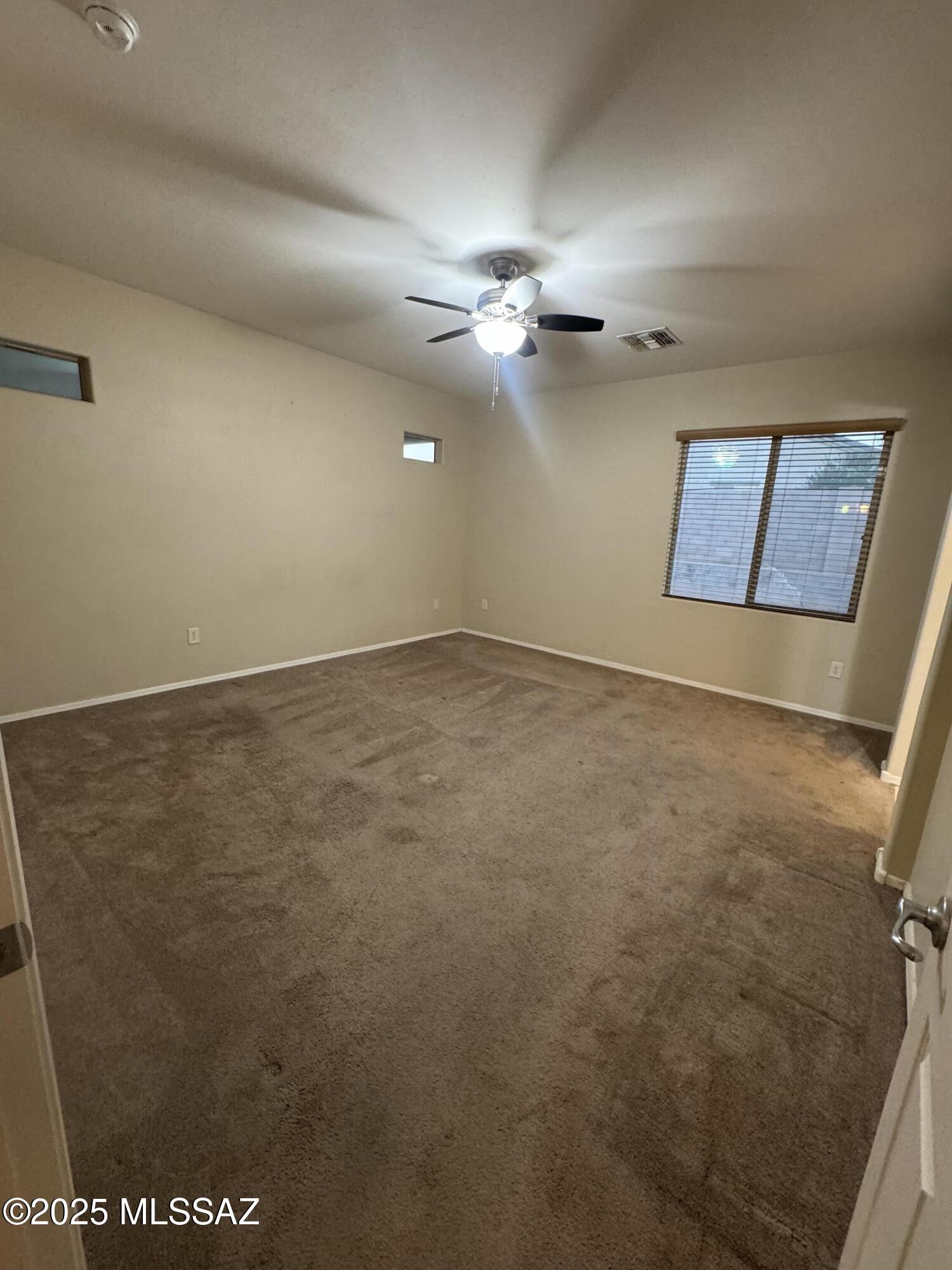 8697 West Denstone Road Marana, AZ 85653 - Photo 15 of 21 Primary suite. Great natural lighting, ceiling fan.