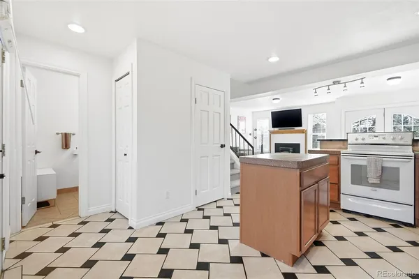 a kitchen with a stove a sink and a refrigerator
