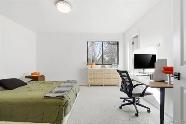 a bedroom with a workspace