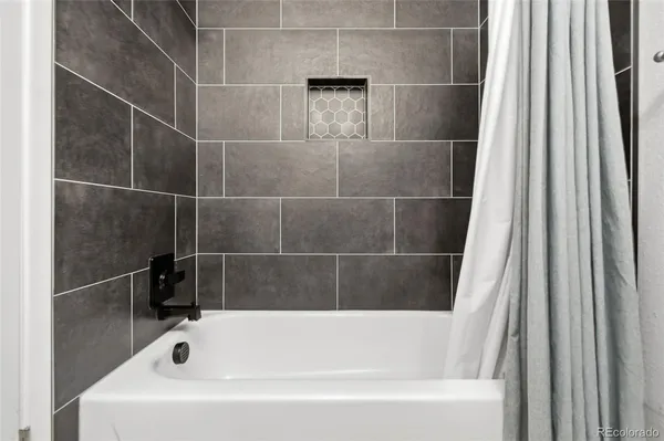 a white bath tub and a shower