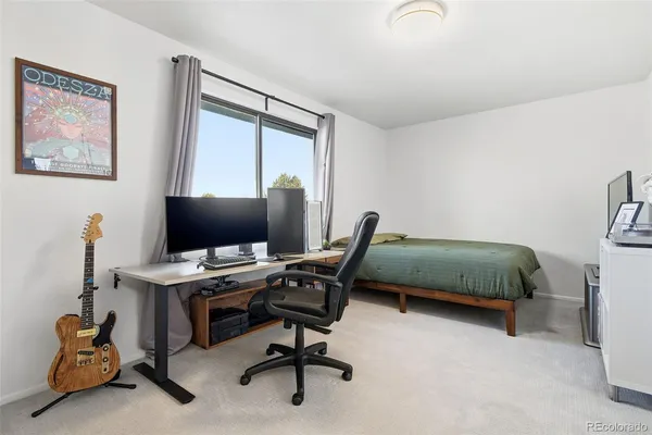 a bedroom with a workspace