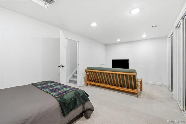 a bedroom with a bed and a chair