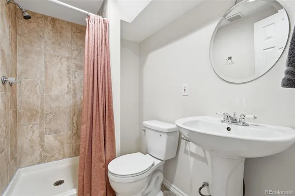 a bathroom with a sink a toilet and a mirror