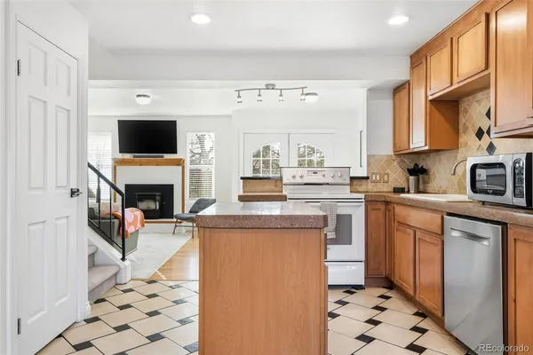 a kitchen with a sink cabinets and appliances
