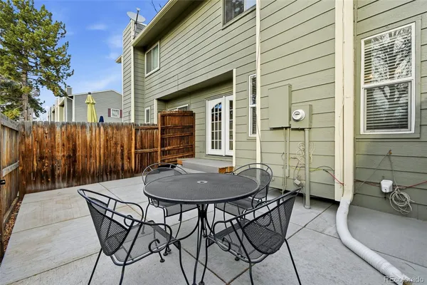 a backyard of a house with table and chairs