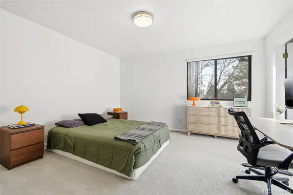 a bedroom with furniture and a window