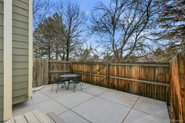 a view of backyard with seating and trees