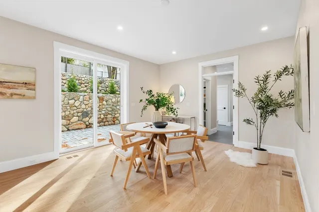 a view of a dining room with furniture window and wooden floor
