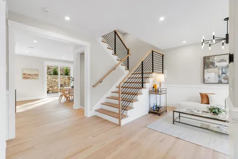 a view of entryway livingroom and hall with wooden floor