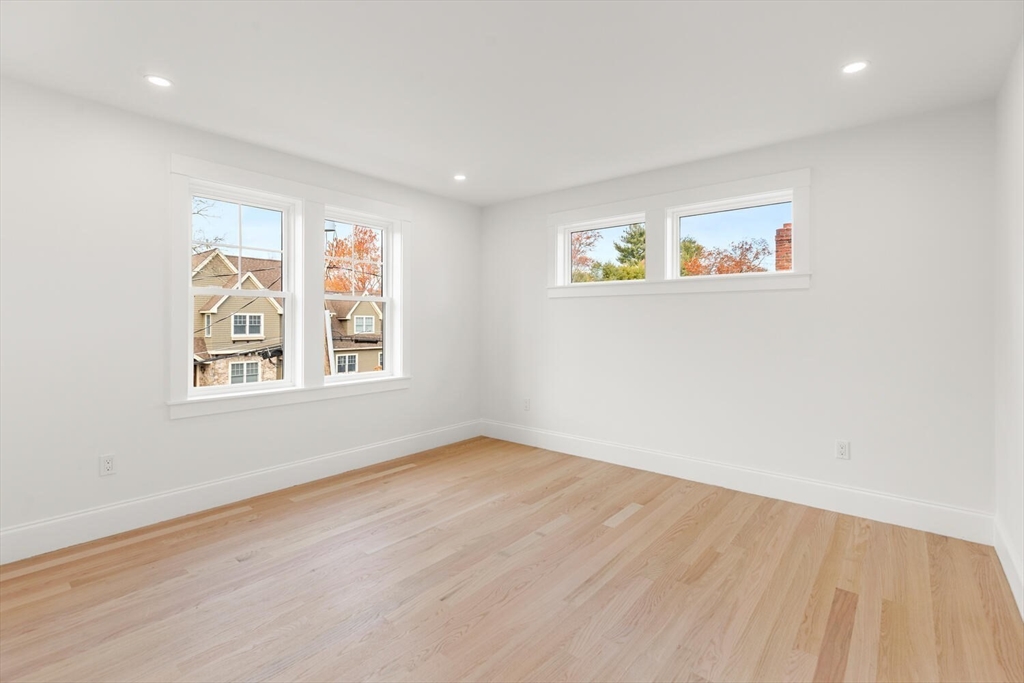 19 Town Way Winchester, MA 01890 - Photo 20 of 42 a view of an empty room with a window and wooden floor