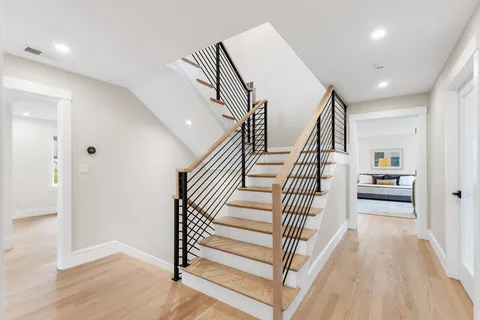 a view of entryway and hall with wooden floor