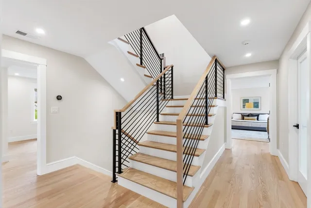 a view of entryway and hall with wooden floor