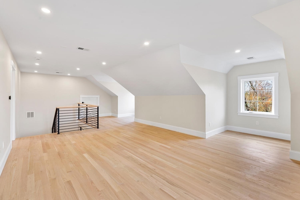 19 Town Way Winchester, MA 01890 - Photo 32 of 42 a view of an empty room with wooden floor and windows