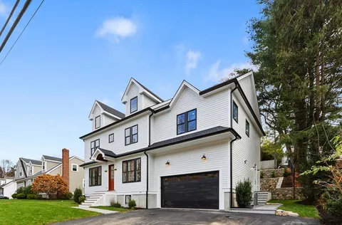 a front view of a house with a garden
