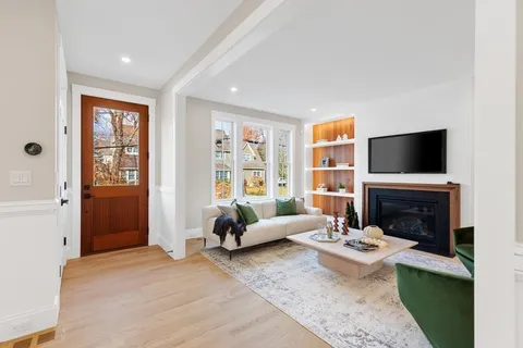 a living room with furniture flat screen tv and a fireplace